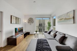 a living room with a couch and a tv at Apart Hotel at Chinatown in Los Angeles