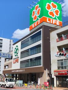 a building with a life sign on top of it at Downtown Tokyo/Taito-gu/2min walk nearest sta/Ueno/Wi-Fi/302 in Tokyo
