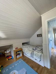 ein kleines Schlafzimmer mit einem Bett im Dachgeschoss in der Unterkunft Koselig hus med fin utsikt 