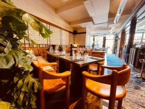 a restaurant with a long bar with wooden chairs at Boutique Hotel Saint-Géry in Brussels