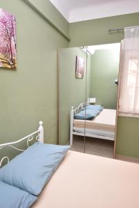 a bedroom with a mirror next to a bed at Prive Apartment Thessaloniki-Easy Parking in Thessaloniki