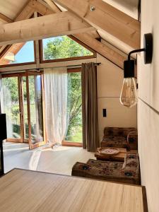 a living room with a large window in a tiny house at Le Cabanon in Saint-Jorioz