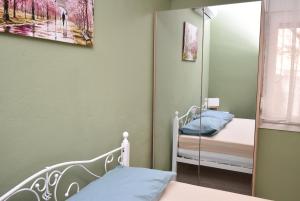 a small bedroom with a mirror and a bed at Prive Apartment Thessaloniki-Easy Parking in Thessaloniki