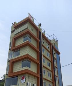 a building with a red car on top of it at Hotel Jay Palace Inn in Solapur