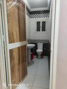 een badkamer met een toilet en een wastafel bij 5شارع سيد معوض اللبيني فيصل جيزه in Caïro