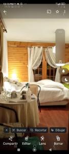a bedroom with a bed and a table with a tableablish at La Maison des Fous in Papudo