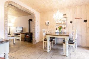 a dining room with a table and a fireplace at Kamin-Haus-Nr-3-mit-Sauna-in-Burg in Fehmarn