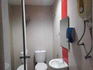 a small bathroom with a toilet and a sink at V Hotel Titiwangsa in Kuala Lumpur