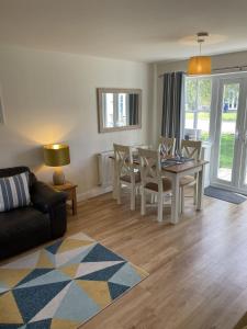a living room with a table and chairs and a couch at High Tide Cottage in Filey