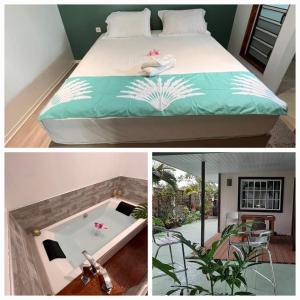 a bedroom with a bed and a bathtub with a table at Fare Miti-Rapa in Tohautu