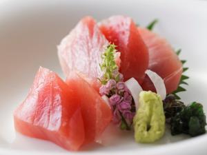 a pile of fruit on a white plate at Hotel Ambia Shofukaku in Yaizu