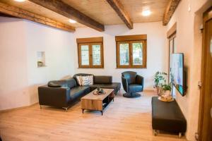 a living room with a couch and a tv at Villa Stanko Međugorje in Čapljina