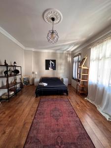 a bedroom with a bed and a rug on the floor at Historic Wooden House with Bosphorus view in Sarıyer