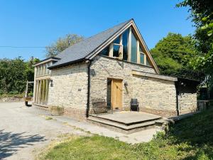 a small stone building with a door and a porch at Poet's Cottage, Steep - Rural Location - Sleeps 6 in Steep