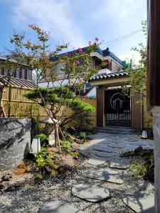 a japanese garden with a gate and a walkway at Seoseoillo in Busan