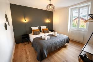a bedroom with a bed and a large window at L'appart' du dessous in Gérardmer +8 photos