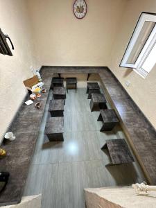 an empty room with a clock on the wall at Gold Hostel in Tashkent +11 photos