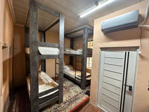 a room with three bunk beds in a room at Gold Hostel in Tashkent
