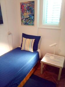 a small bedroom with a bed and a table at Riki in Split
