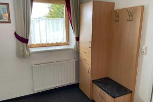 a bedroom with a dresser and a window at Wohnung Kirchdach 145 - Naviser Huette in Navis