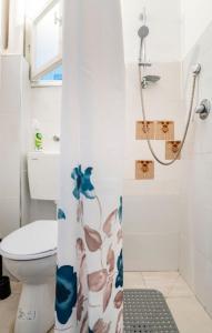 a bathroom with a toilet and a shower stall at "One minute from sea" from Shneider Apartments in Haifa