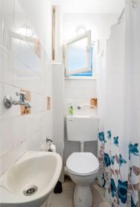 a bathroom with a white toilet and a sink at "One minute from sea" from Shneider Apartments in Haifa