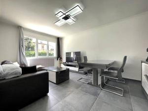 a living room with a couch and a desk at Maison Bleue ※ Carcassonne in Carcassonne