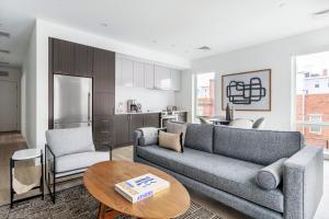 a living room with a couch and a table at Central Sq 3BR w WD nr MIT Kendall Sq BOS-367 in Cambridge