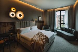 a hotel room with a bed and a chair at Hotel Pinar Plaza in Madrid