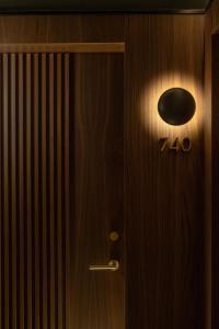 a wooden door with a clock on it at Hotel Pinar Plaza in Madrid