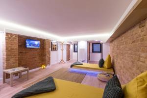a living room with a brick wall and a couch at Hevals Spa & Design Apartment in Berlin