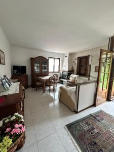 a kitchen and living room with a couch and a table at Holiday Home Delo - Cremia in Cremia