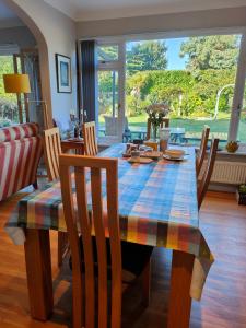 a dining room table with a plaid table cloth on it at Bracken Lodge in Merston