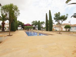 a courtyard with a pool and trees and buildings at Villa Amyali by Rentalole Mar Menor Golf Resort in Torre-Pacheco