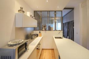 a kitchen with a microwave and a counter top at Annecy apt w car park near downtown and lake in Annecy