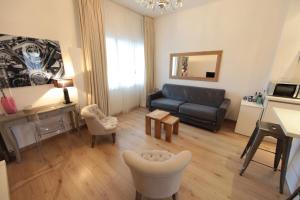 a living room with a couch and a table at Annecy apt w car park near downtown and lake in Annecy