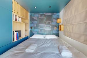 a bedroom with a large white bed with two pillows at Des Bulles en rooftop in Annecy