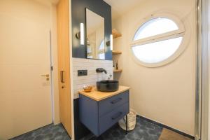a bathroom with a sink and a window at Des Bulles en rooftop in Annecy +20 photos