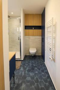 a bathroom with a toilet and a sink at Des Bulles en rooftop in Annecy