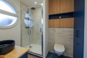 a bathroom with a shower and a sink and a toilet at Des Bulles en rooftop in Annecy +13 photos