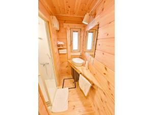 a bathroom with wooden walls and a sink and a toilet at Lagasis Ishigaki Nosako Villa - Vacation STAY 74548v in Ibaruma +20 photos