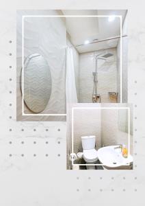 Baño blanco con aseo y espejo en White hostel Mongolia, en Ulán Bator
