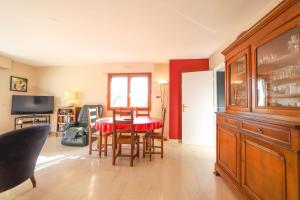 a kitchen with a table and chairs and a dining room at La Pause annécienne appartement familial in Annecy