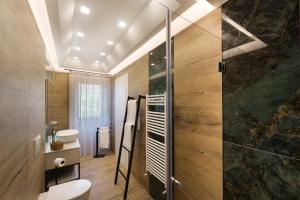 a bathroom with a shower and a toilet and a sink at La casa di Mimí in Vico Equense +23 photos