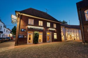 a brick building on a city street at night at Hotel & Gasthaus Nagel GmbH in Südlohn
