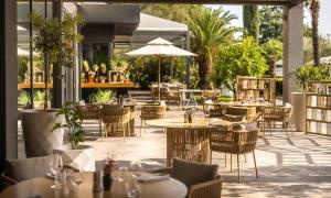 an outdoor dining area with tables and chairs at Aminess Vival Maestral Hotel in Novigrad Istria