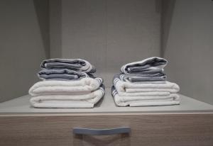 two stacks of towels sitting on a shelf in a bathroom at Grand Gîte - Le Saint-Chrirtophe in Châteauroux