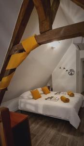 a bedroom with a bed in an attic at Grand Gîte - Le Saint-Chrirtophe in Châteauroux