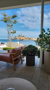 a patio with a view of the beach and the ocean at Apartment Babbo in Rovinj