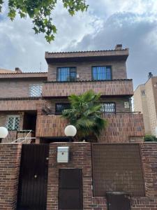 um edifício de tijolos com uma palmeira em frente em C9 Magnífico apartamento en zona tranquila em Madri